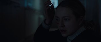 Movie still from “The Burning Sea” (2021), directed by John Andreas Andersen – A woman holding a cell phone up to her face; Close Up shot, Over the shoulder angle