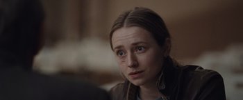 Movie still from “The Burning Sea” (2021), directed by John Andreas Andersen – A person looking at the camera; Close Up shot, Over the shoulder angle