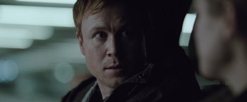 Movie still from “The Burning Sea” (2021), directed by John Andreas Andersen – A person looking at the camera; Close Up shot, Over the shoulder angle