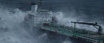 Movie still from “The Burning Sea” (2021), directed by John Andreas Andersen – A large ship in the middle of the ocean; Extreme Wide shot, High angle