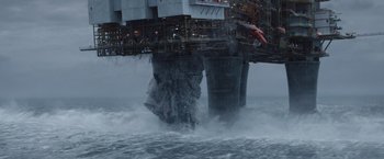 Movie still from “The Burning Sea” (2021), directed by John Andreas Andersen – A view of an oil rig from the water; Extreme Wide shot, Low angle