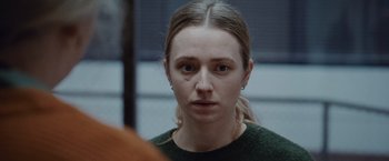 Movie still from “The Burning Sea” (2021), directed by John Andreas Andersen – A young woman is looking into the camera; Close Up shot, Over the shoulder angle