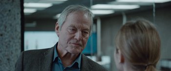 Movie still from “The Burning Sea” (2021), directed by John Andreas Andersen – An older man is looking at a young boy; Close Up shot, Over the shoulder angle