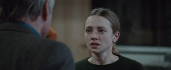 Movie still from “The Burning Sea” (2021), directed by John Andreas Andersen – A young woman looking at a man in a black shirt; Close Up shot, Over the shoulder angle