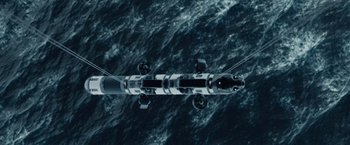 Movie still from “The Burning Sea” (2021), directed by John Andreas Andersen – An aerial view of a boat in the ocean; Extreme Wide shot, Overhead angle