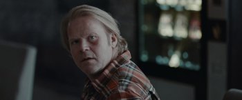 Movie still from “The Burning Sea” (2021), directed by John Andreas Andersen – A person wearing a plaid shirt; Close Up shot, Over the shoulder angle
