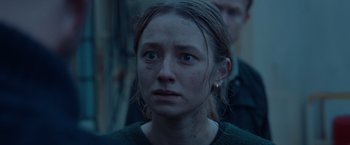 Movie still from “The Burning Sea” (2021), directed by John Andreas Andersen – A person looking at the camera; Close Up shot, Over the shoulder angle
