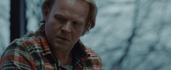 Movie still from “The Burning Sea” (2021), directed by John Andreas Andersen – A person wearing a plaid shirt; Close Up shot, Over the shoulder angle