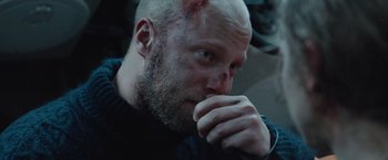 Movie still from “The Burning Sea” (2021), directed by John Andreas Andersen – A bald man with a shaved head and a shaved head; Close Up shot, Over the shoulder angle