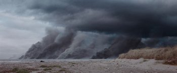 Movie still from “The Burning Sea” (2021), directed by John Andreas Andersen – A large cloud of black smoke billows in the sky; Extreme Wide shot, Low angle