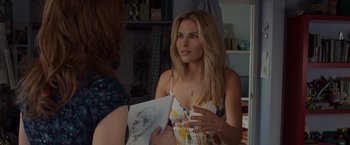 Movie still from “The Cabin in the Woods” (2011), directed by Drew Goddard – A woman is holding a drawing while talking to another woman; Close Up shot, Over the shoulder angle