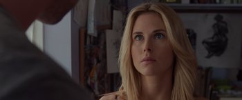 Movie still from “The Cabin in the Woods” (2011), directed by Drew Goddard – A beautiful blonde woman with blue eyes looking at the camera; Close Up shot, Over the shoulder angle