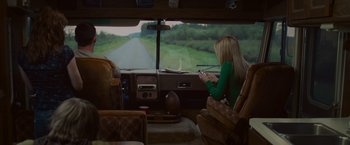 Movie still from “The Cabin in the Woods” (2011), directed by Drew Goddard – A woman sitting in the back of an rv looking out the window; Wide shot, High angle