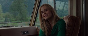 Movie still from “The Cabin in the Woods” (2011), directed by Drew Goddard – A woman sitting in a car smiling for the camera; Close Up shot, Over the shoulder angle