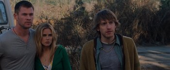 Movie still from “The Cabin in the Woods” (2011), directed by Drew Goddard – A man and a woman standing next to each other in front of trees; Medium shot, Over the shoulder angle