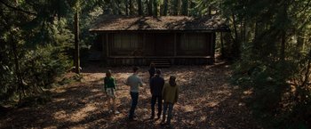 Movie still from “The Cabin in the Woods” (2011), directed by Drew Goddard – A group of people standing in front of a log cabin; Extreme Wide shot, High angle
