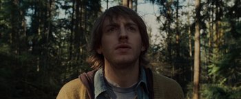 Movie still from “The Cabin in the Woods” (2011), directed by Drew Goddard – A person with a backpack in the woods; Close Up shot, Low angle