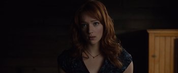 Movie still from “The Cabin in the Woods” (2011), directed by Drew Goddard – A woman with red hair wearing a blue shirt; Close Up shot, Over the shoulder angle