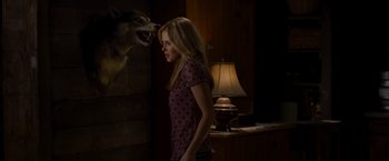 Movie still from “The Cabin in the Woods” (2011), directed by Drew Goddard – A woman standing in front of a dog's head; Medium shot, Over the shoulder angle