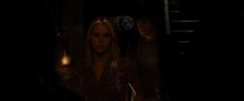 Movie still from “The Cabin in the Woods” (2011), directed by Drew Goddard – A woman standing next to a man in a dark room; Medium shot, Over the shoulder angle