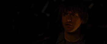 Movie still from “The Cabin in the Woods” (2011), directed by Drew Goddard – A man with long brown hair is in the dark; Close Up shot, Over the shoulder angle