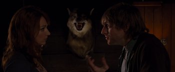 Movie still from “The Cabin in the Woods” (2011), directed by Drew Goddard – A man standing in front of a fake wolf; Close Up shot, Over the shoulder angle