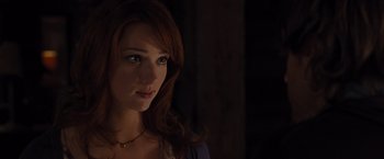 Movie still from “The Cabin in the Woods” (2011), directed by Drew Goddard – A beautiful woman with red hair and blue eyes looking at the camera; Close Up shot, Over the shoulder angle