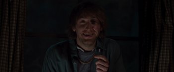 Movie still from “The Cabin in the Woods” (2011), directed by Drew Goddard – A man holding a cell phone up to his face; Close Up shot, Low angle