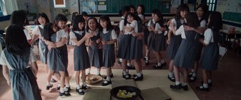 Movie still from “The Cabin in the Woods” (2011), directed by Drew Goddard – A group of young asian school girls standing next to each other; Wide shot, High angle