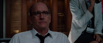 Movie still from “The Cabin in the Woods” (2011), directed by Drew Goddard – A man wearing a white shirt and a black tie; Close Up shot, Low angle