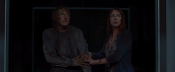 Movie still from “The Cabin in the Woods” (2011), directed by Drew Goddard – A man and a woman with blood on their hands; Medium shot, Over the shoulder angle