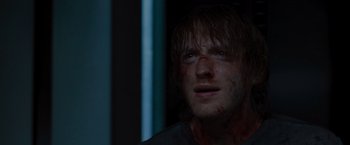 Movie still from “The Cabin in the Woods” (2011), directed by Drew Goddard – A person with blood all over his face; Close Up shot, Over the shoulder angle