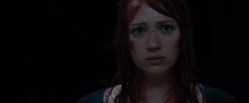 Movie still from “The Cabin in the Woods” (2011), directed by Drew Goddard – A young woman with blood all over her face; Close Up shot, High angle