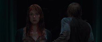 Movie still from “The Cabin in the Woods” (2011), directed by Drew Goddard – A woman and a man in a dark room; Close Up shot, Over the shoulder angle