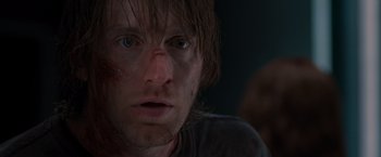Movie still from “The Cabin in the Woods” (2011), directed by Drew Goddard – A person with a bruise on his face; Close Up shot, Low angle