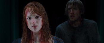 Movie still from “The Cabin in the Woods” (2011), directed by Drew Goddard – A woman with red hair is looking at a man with red hair; Close Up shot, Over the shoulder angle