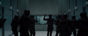 Movie still from “The Cabin in the Woods” (2011), directed by Drew Goddard – A group of men standing next to each other in front of a window; Wide shot, Low angle