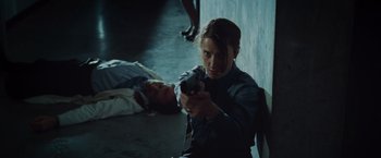 Movie still from “The Cabin in the Woods” (2011), directed by Drew Goddard – A woman sitting on the ground holding a video game controller; Medium shot, Over the shoulder angle