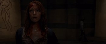Movie still from “The Cabin in the Woods” (2011), directed by Drew Goddard – A woman with red hair is looking at the camera; Close Up shot, High angle