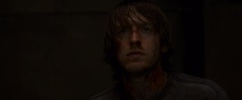 Movie still from “The Cabin in the Woods” (2011), directed by Drew Goddard – A person wearing a black shirt; Close Up shot, Low angle