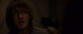 Movie still from “The Cabin in the Woods” (2011), directed by Drew Goddard – A man's face while holding a cell phone; Close Up shot, Over the shoulder angle