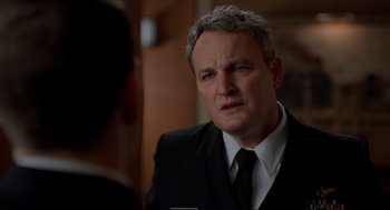 Movie still from “The Caine Mutiny Court-Martial” (2023), directed by William Friedkin – A man in a suit and tie looking at another man in a suit and tie; Close Up shot, Over the shoulder angle