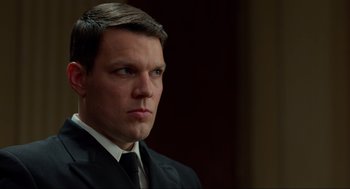 Movie still from “The Caine Mutiny Court-Martial” (2023), directed by William Friedkin – A person wearing a suit and tie; Close Up shot, Low angle