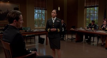 Movie still from “The Caine Mutiny Court-Martial” (2023), directed by William Friedkin – A woman in a military uniform standing in a room; Medium shot, Over the shoulder angle