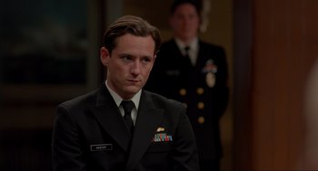 Movie still from “The Caine Mutiny Court-Martial” (2023), directed by William Friedkin – A man in a military uniform is standing next to another man in a uniform; Close Up shot, Over the shoulder angle