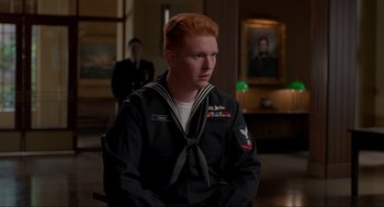 Movie still from “The Caine Mutiny Court-Martial” (2023), directed by William Friedkin – A man with red hair in a navy uniform; Medium shot, Over the shoulder angle