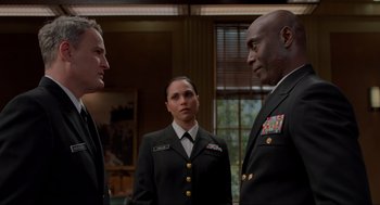 Movie still from “The Caine Mutiny Court-Martial” (2023), directed by William Friedkin – Three people in military uniforms standing next to each other; Medium shot, Over the shoulder angle