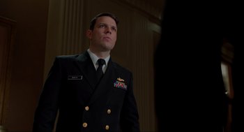 Movie still from “The Caine Mutiny Court-Martial” (2023), directed by William Friedkin – A man in a military uniform standing in front of a wall; Close Up shot, Low angle