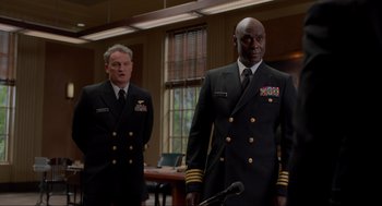 Movie still from “The Caine Mutiny Court-Martial” (2023), directed by William Friedkin – Two men in military uniforms standing in a room; Medium shot, Low angle