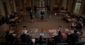 Movie still from “The Caine Mutiny Court-Martial” (2023), directed by William Friedkin – A group of men in suits sitting around a table; Extreme Wide shot, High angle